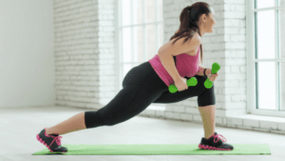 The girl performed an exercise with dumbbells